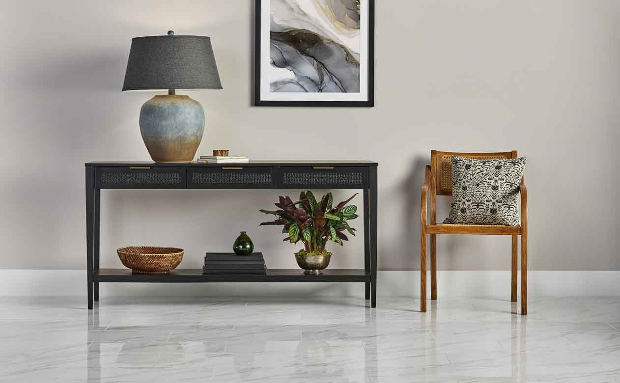 polished marble tile in modern entryway with wicker chair and table